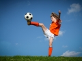 Child kicking playing football